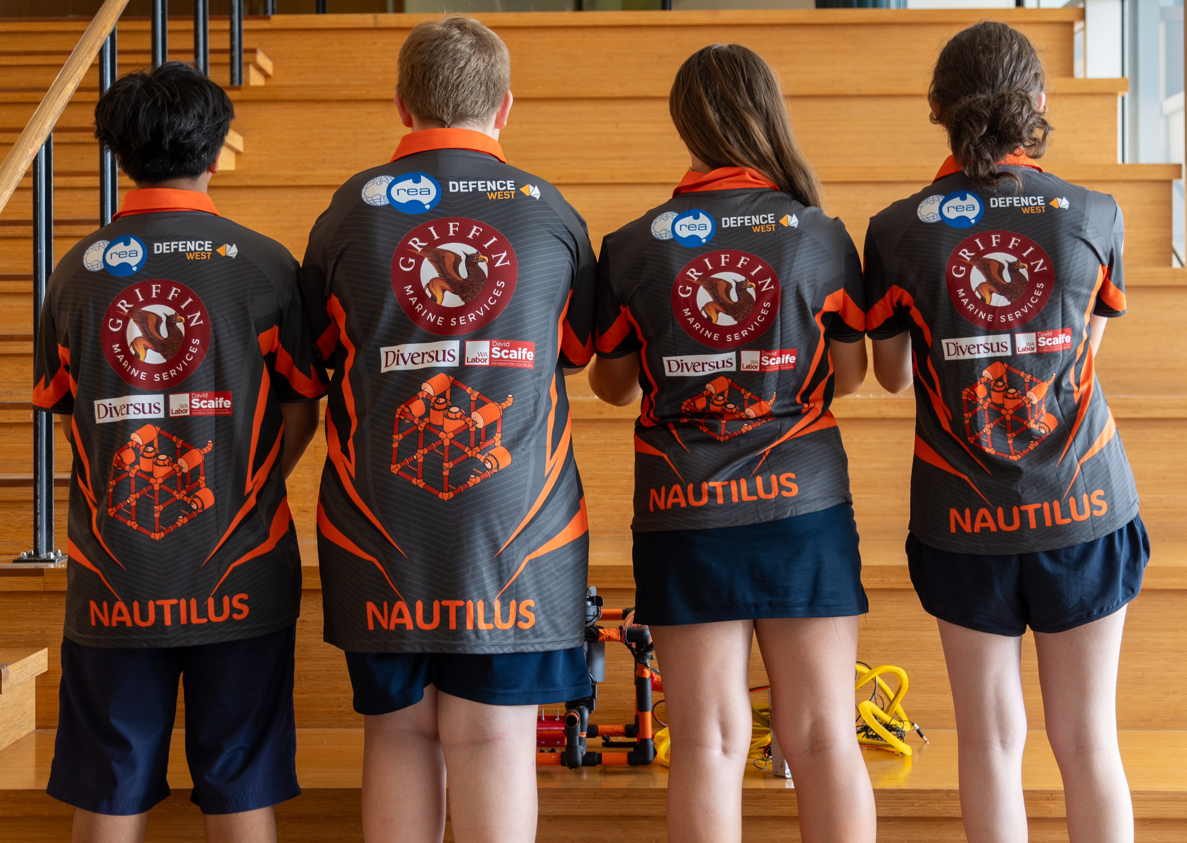 Nautilus students showing of the back of their uniform